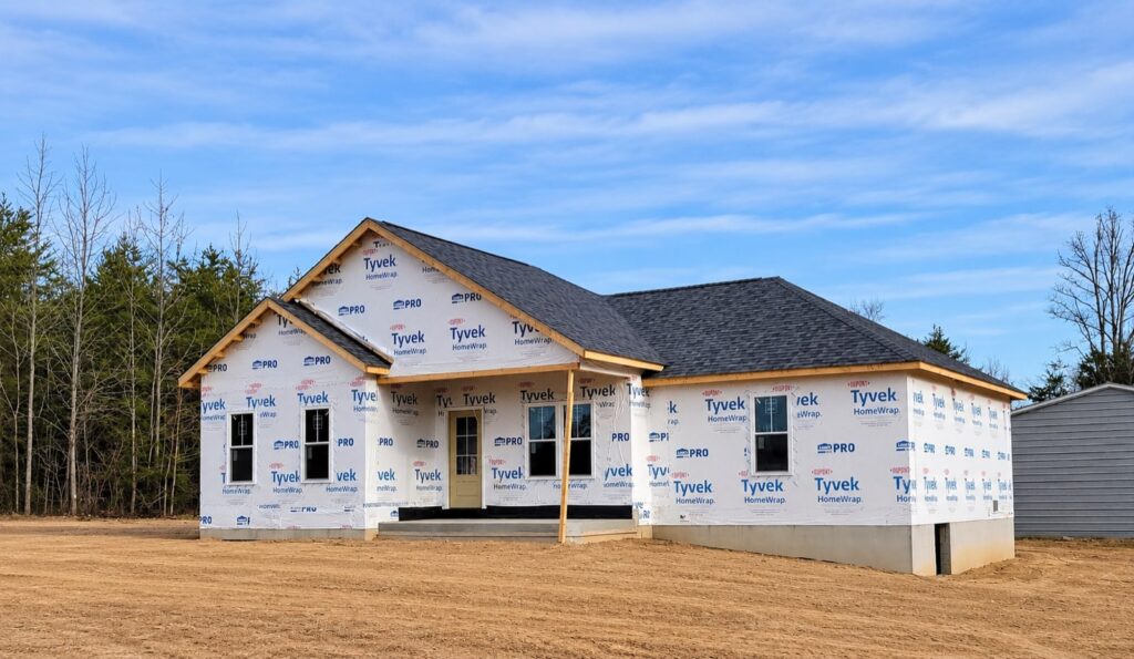A new custom home wrapped and roofed, under construction in Central Virginia